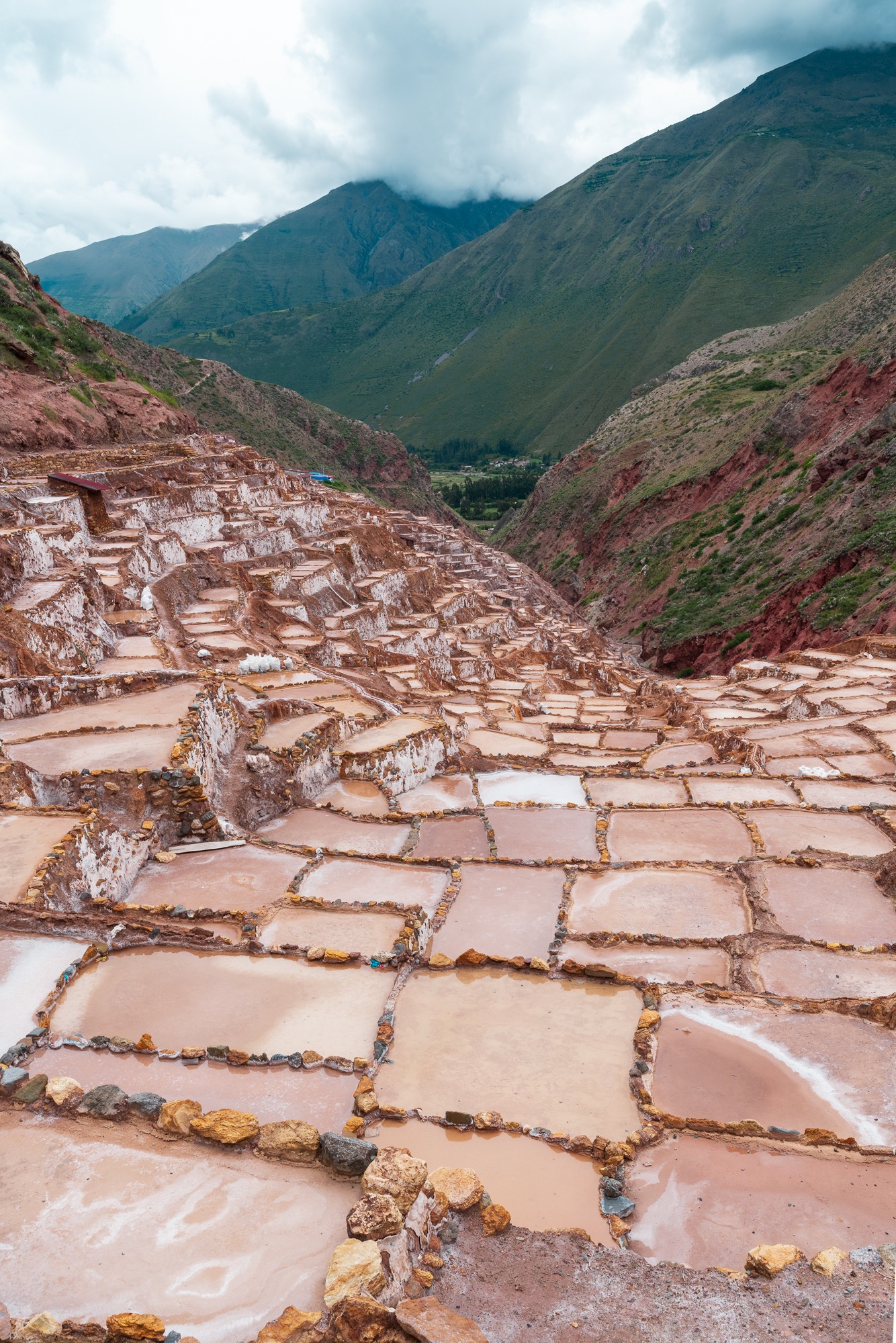 An intricate patchwork of salt pans steps down the mountainside at the Maras salt terraces in Peru.